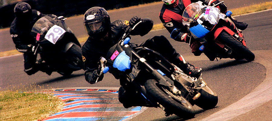 Portland personal injury attorney Michael Colbach riding on his motorcycle at Portland international raceway at the front of the group of motorcyclists.
