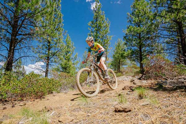 Bicycle Attorney team cyclist descends Oregon Bicycle Racing Sisters Stampede mountain bike race in Sisters, Oregon.