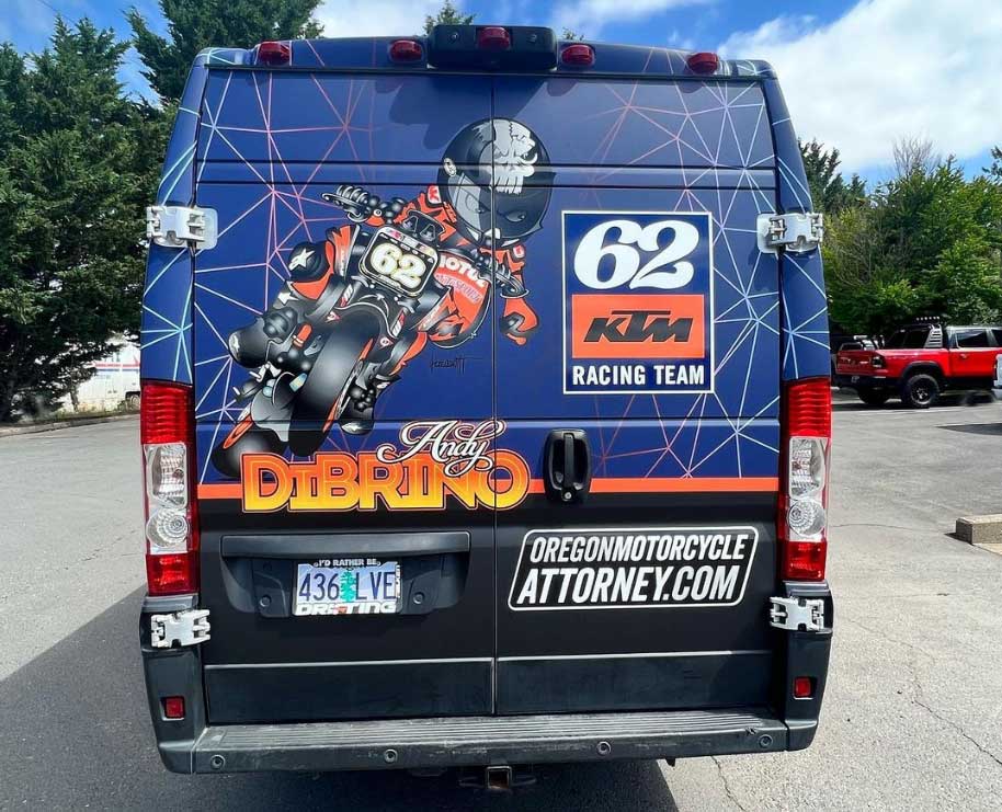 Portland, Oregon pro motorcycle racer Andy DiBrino Oregon Motorcycle Accident Attorney branded van rear view with great cartoon of Andy.