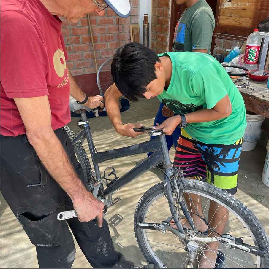 Kevin working with the Casa Girasoles kids repairing and tuning all the youth size bicycles they had.