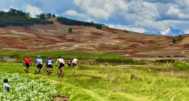 Peru gravel camp bicycle attorney cycling team riding through a verdant green valley at nearly ten thousand feet elevation and clear skies in November 2025